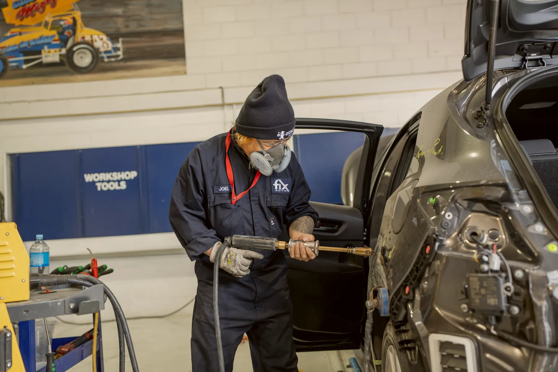 Technician working on a damaged door at Fix Auto Mt Wellington