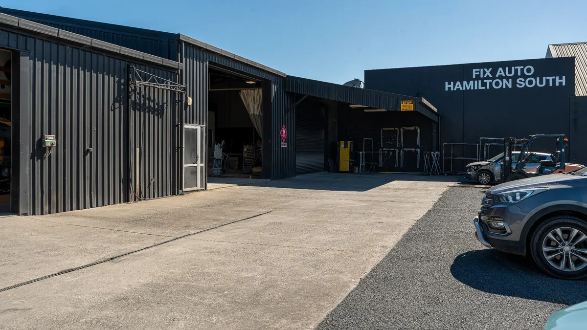 Fix Auto Hamilton South signage on the workshop